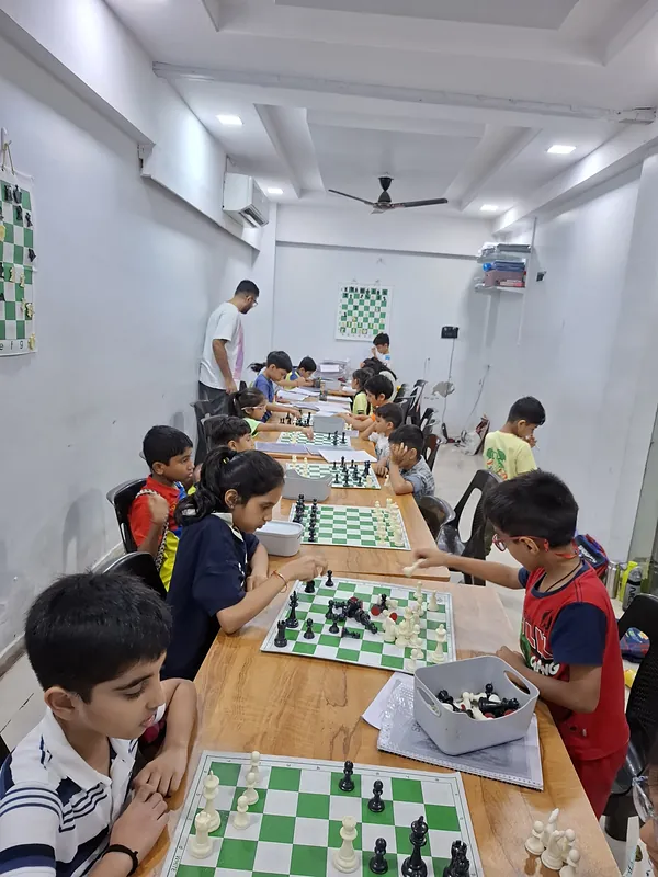 Students in a practice game at Surat Chess Club, Vesu, for families in City Light