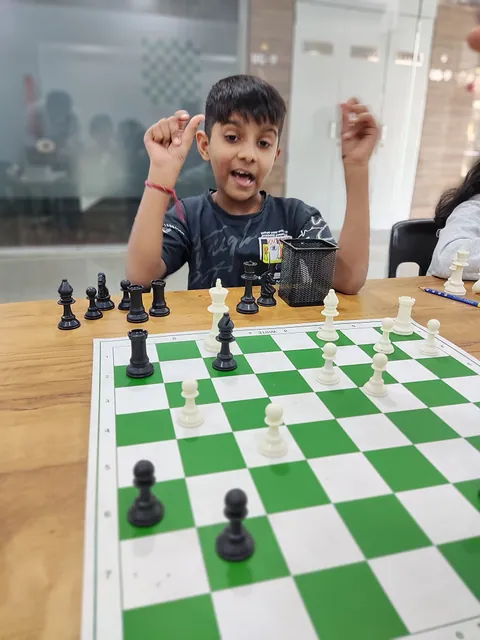 A boy cheering at the board after winning his practice game