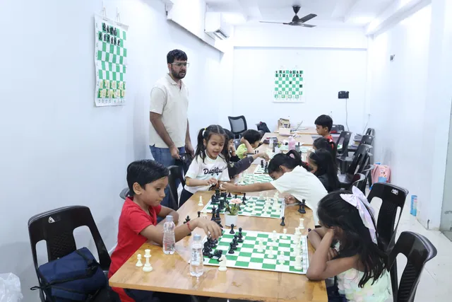 Children playing practice games at the club while the coach watches