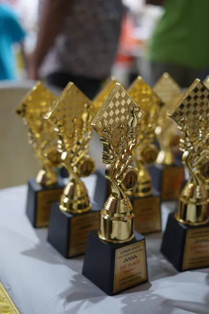 Gold trophies lined up for the Junior Rapid Chess Championship prize giving