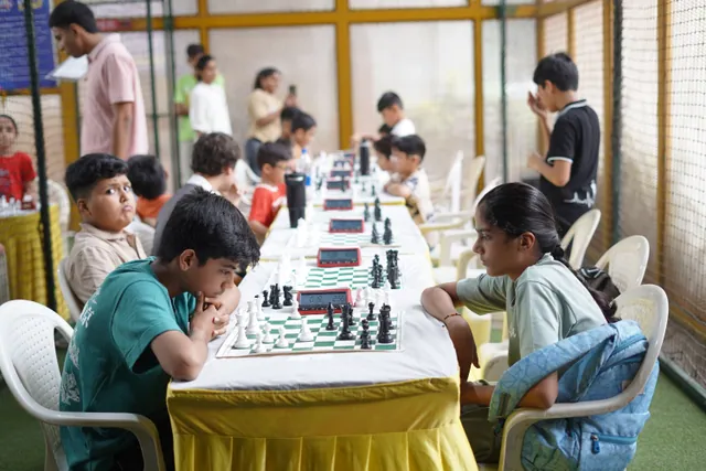 Juniors playing down the length of a long table at HopUp Sports Arena