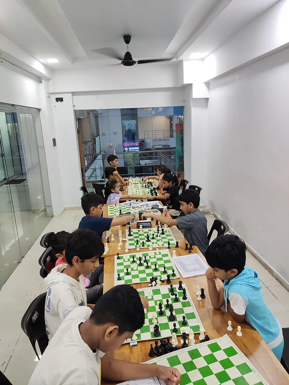 Students playing chess at Surat Chess Club in Vesu, Surat